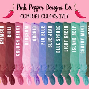 May include: A collection of 15 fabric swatches in various colors, including ivory, mustard, crimson, chili, crunch berry, blossom, orchid, flo blue, blue jean, blue spruce, light green, island reef, chalky mint, hemp, and pepper. The swatches are arranged in a row and tied in a knot at the bottom. The text "COMFORT COLORS 1717" and "Pink Pepper Designs Co." is displayed above the swatches.