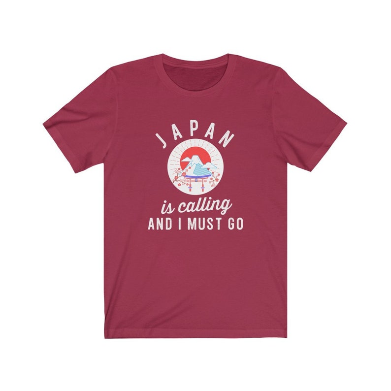 May include: Red t-shirt with a white graphic of a Japanese mountain scene and the text "JAPAN is calling AND I MUST GO."
