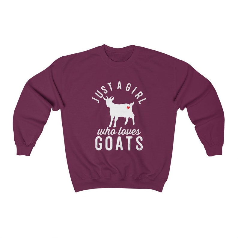May include: Burgundy sweatshirt with a white silhouette of a goat and the text "Just a girl who loves goats".