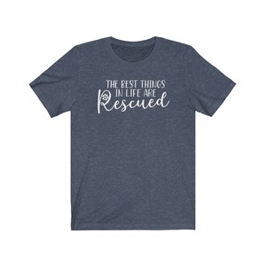 May include: A dark blue t-shirt with the text "The best things in life are Rescued" in white lettering with a paw print icon.