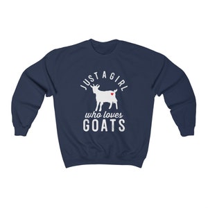 May include: Navy blue sweatshirt with a white graphic of a goat with a red heart. The text reads "Just a girl who loves goats".