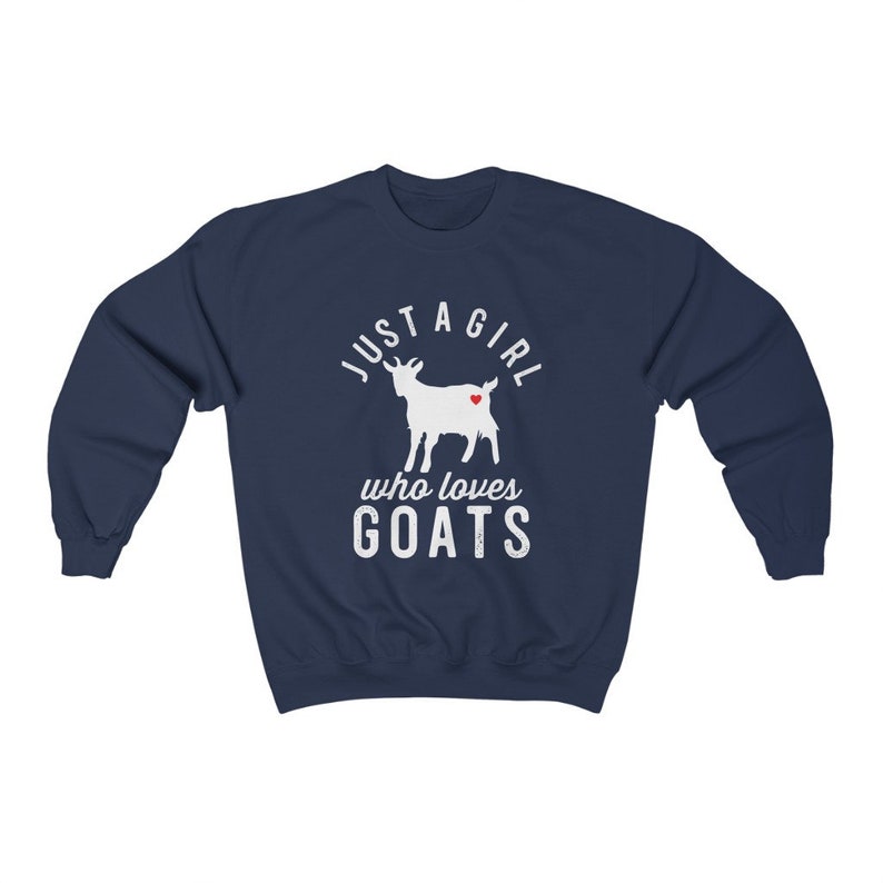 May include: Navy blue sweatshirt with a white graphic of a goat with a red heart. The text reads "Just a girl who loves goats".