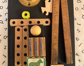 Assemblage Art, Found Object Art: "It's a Puzzle?" - Wooden Ruler, Zebra block, Puzzle Pieces, Brass Appliance w/Book as Canvas