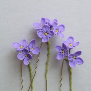 Lilac hair pins with small flowers.