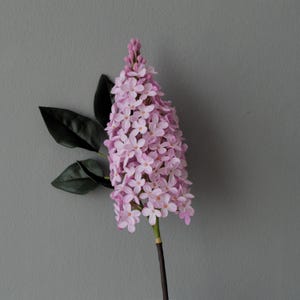 A branch of lilacs . Lilac flowers. Realistic lilacs from cold porcelain. Lilacs in a vase.
