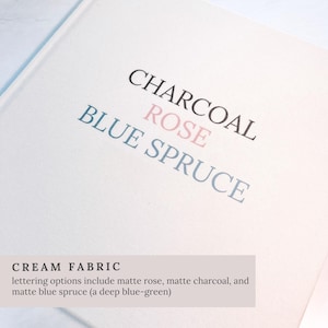 May include: Cream fabric with the words "CHARCOAL", "ROSE", and "BLUE SPRUCE" printed in black, pink, and blue. The text "CREAM FABRIC" is at the bottom, with lettering options listed below.