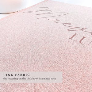 May include: Close-up of a pink fabric with the word "Macy's" in a matte rose color. The fabric has a textured appearance. The text "PINK FABRIC" and a description are at the bottom of the image.