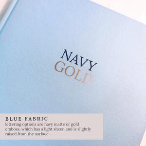 May include: A light blue fabric with the words "NAVY GOLD" embossed in navy and gold. The text is slightly raised from the surface. The bottom of the image has text that reads "BLUE FABRIC".