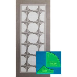 May include: A gray and white quilt with a geometric pattern of circles. The quilt is made with a template set that includes two clear acrylic templates. The templates are labeled "Cuttlebug" and "Soft Virginia Snowflake 4" Triangle Template".