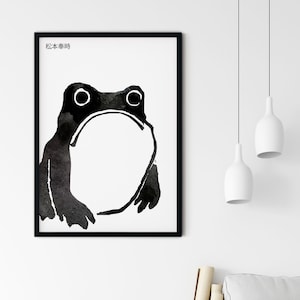 Puede incluir: Ilustración de acuarela en blanco y negro de una rana en un marco negro. El texto "松本泰時" está en la parte superior del marco.