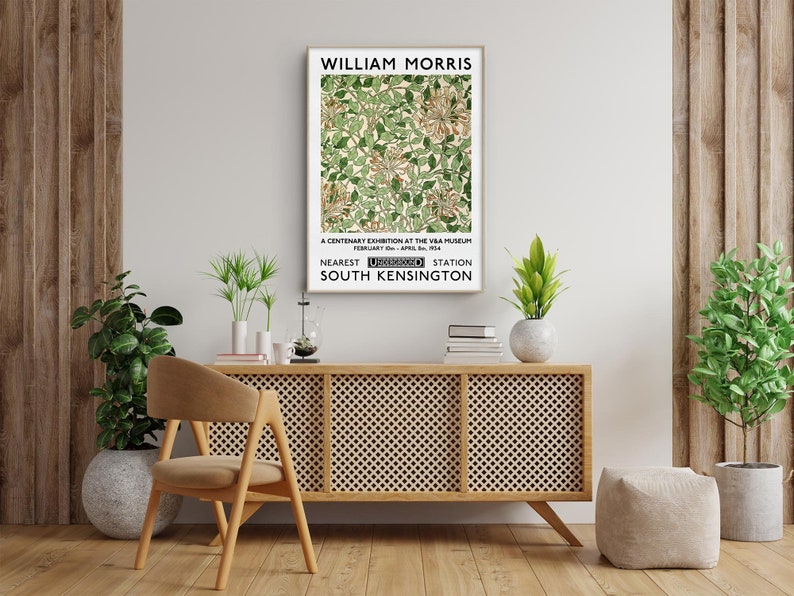 May include: A vintage poster advertising a William Morris exhibition at the V&A Museum in London. The poster features a floral design in shades of green and white. The text reads "William Morris", "A Centenary Exhibition at the V&A Museum", "February 1st - April 30th 1964", "Nearest Underground Station South Kensington".