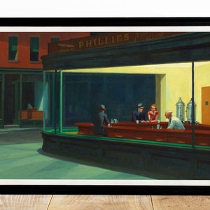 May include: Framed print of Edward Hopper's "Nighthawks" painting. The artwork depicts a late-night diner scene with three patrons and a server. The diner is brightly lit, contrasting with the dark street outside. The frame is black.