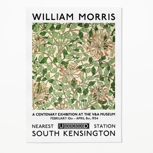 May include: A vintage poster advertising a William Morris exhibition at the V&A Museum in London. The poster features a floral pattern in shades of green, orange, and white. The text reads "William Morris", "A Centenary Exhibition at the V&A Museum", "February 10th - April 8th, 1934", "Nearest Underground Station", and "South Kensington".