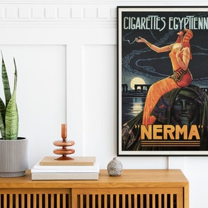 May include: Vintage poster advertising "Nerma" Egyptian cigarettes. The poster features a woman in a flowing orange dress sitting on a sphinx, with a moon and pyramids in the background.