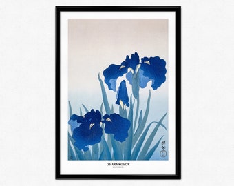 May include: A vintage Japanese woodblock print of blue iris flowers with green leaves against a light blue and beige background. The print is titled "Ohara Koson Iris Flowers".