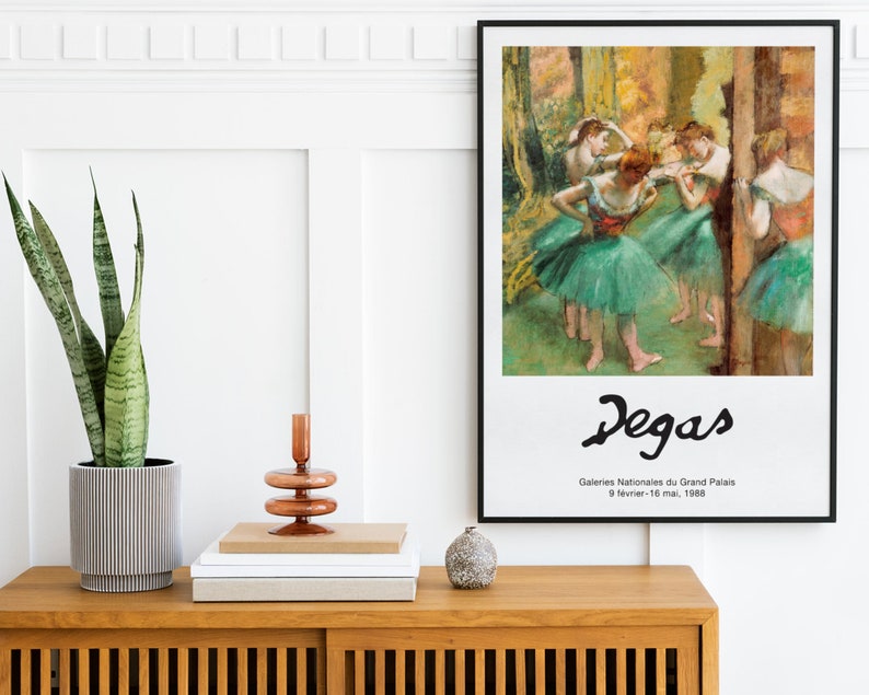 May include: A framed poster of a painting by Edgar Degas depicting dancers in a ballet studio. The poster is titled "Degas" and includes the text "Galeries Nationales du Grand Palais 9 fevrier - 16 mai, 1988".