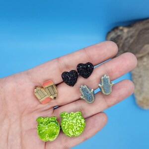 Apple, hamsa hands, pencils and heart stud earrings