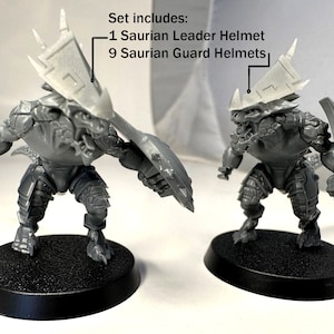 May include: Two unpainted plastic miniatures of Saurian warriors, each equipped with a shield and helmet. The set includes one Saurian Leader Helmet and nine Saurian Guard Helmets. The figures stand on black circular bases.
