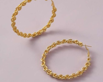 May include: A pair of gold-toned hoop earrings with a rope-like design.