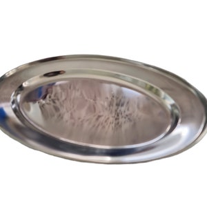 May include: A silver oval serving platter with a raised rim.
