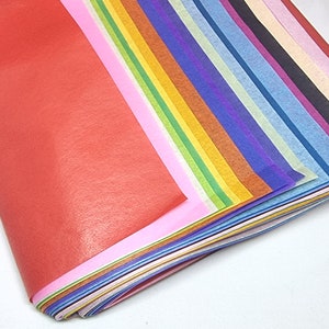 May include: A stack of colorful tissue paper in various shades of red, pink, orange, yellow, green, blue, purple, and white.