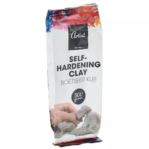 May include: A bag of Artist Self-Hardening Clay, 500 grams, for sculpting and crafting. The bag features a colourful design and a photo of a hand shaping the clay.