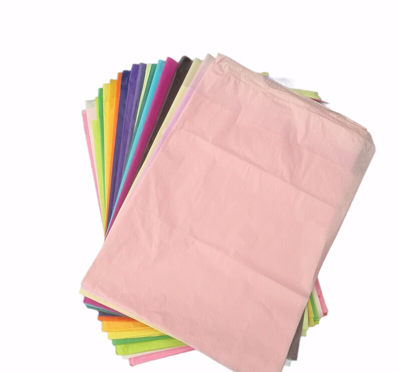 May include: A stack of colorful tissue paper in various shades of pink, purple, blue, green, yellow, orange, and red. The tissue paper is folded and arranged in a fan shape.