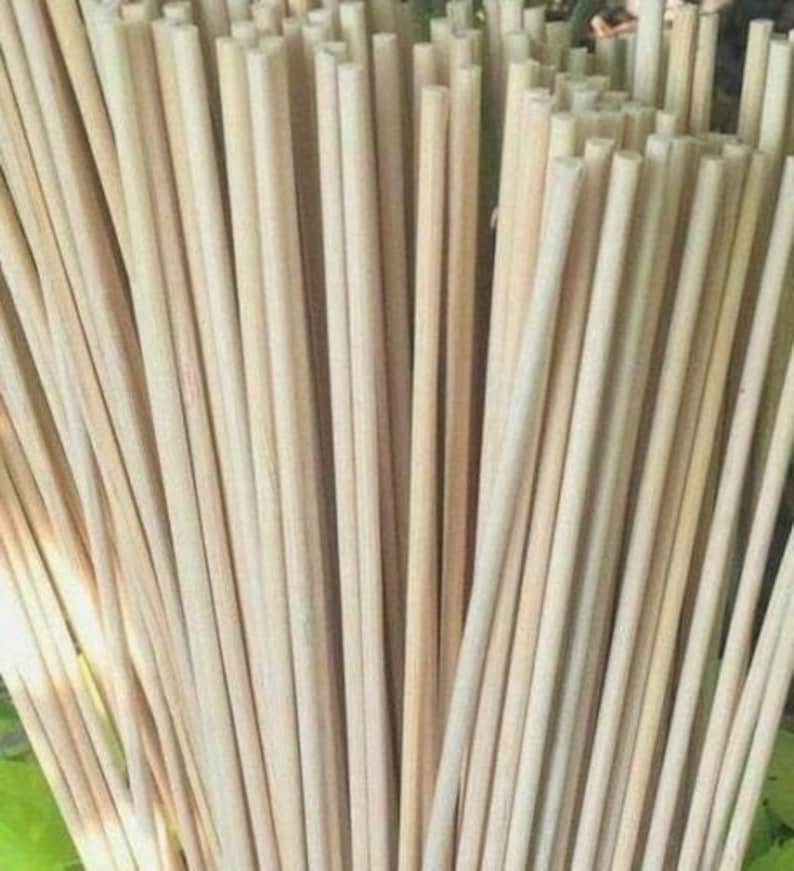 May include: A bundle of natural, unpainted wooden dowels. The dowels are smooth and have a light brown color. They are all the same length and diameter.