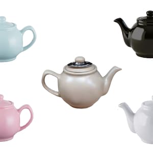 May include: A selection of ceramic teapots in pastel shades: pale blue, black, cream, pink, and white. Each teapot features a lid, spout, and handle. The teapots are presented against a white backdrop.