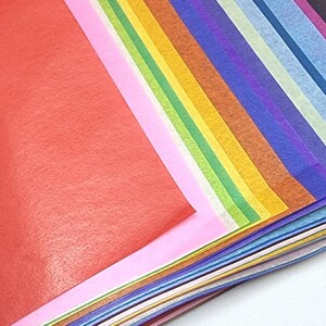 May include: A stack of colorful tissue paper in various shades of red, pink, white, green, yellow, orange, brown, blue, purple, and light blue.