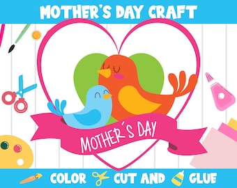 Op de afbeelding: Een knutselproject voor Moederdag met twee vogels in een hartvorm. De vogels zijn blauw en oranje met gele accenten. Het hart is roze met een roze lint waarop "Moederdag" staat. De knutselinstructies zijn "Kleur, Knip en Plak".