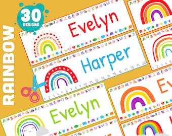Può includere: Etichette per nomi da tavolo arcobaleno modificabili per l'uso in classe. Le etichette presentano un arcobaleno con un viso sorridente e nuvole, insieme al testo "Editable PowerPoint".