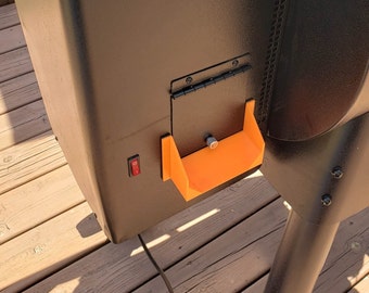 May include: A black metal smoker with an orange plastic ash pan and a black switch on the side.