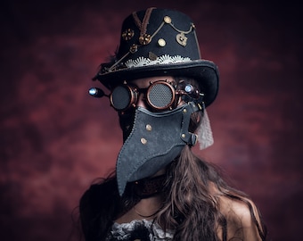 May include: A person wearing a black top hat with embellishments, steampunk goggles, and a black leather plague doctor mask with a long beak.