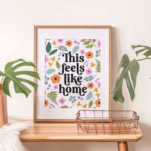 Pressed flower print home decor with This Feels Like Home text. For colourful botanical home poster decor