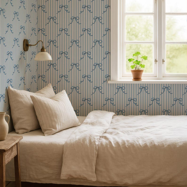 Pirouette Blue Bow Wallpaper with Candy Stripe and Hand Drawn Ribbon by Oh SO Daisy in a Soft Feminine Bedroom Interior