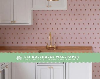 May include: A miniature kitchen scene featuring white cabinets, a gold faucet, and pink wallpaper with a repeating strawberry pattern. The text on the image reads: 1:12 DOLLHOUSE WALLPAPER 50CM SHEETS - BRITISH MADE - REAL WALLPAPER.