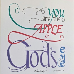 May include: A hand-lettered art print featuring the text "you are the APPLE OF God's eye" in various colors including teal, red, purple, and blue. The calligraphy includes decorative flourishes and the signature "hutchcraft" with "Zechariah 2:8".