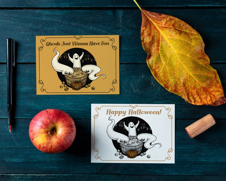 May include: Two Halloween greeting cards with a black and white illustration of ghosts in a cauldron. The top card has a yellow background and says "Ghouls Just Wanna Have Fun". The bottom card has a white background and says "Happy Halloween!"
