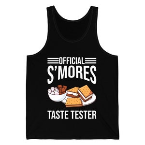 May include: Black vest top with the words "OFFICIAL S'MORES TASTE TESTER" in white. The graphic includes a plate of s'mores, marshmallows, and chocolate. A fun, casual top for camping or outdoor activities.