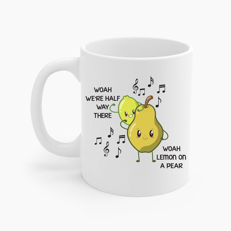 May include: White ceramic mug featuring a cartoon illustration of a lemon and pear with musical notes. The text on the mug reads "Woah We're Half Way There" and "Woah Lemon on a Pear".