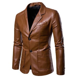 May include: A brown leather blazer with a two-button closure, a notched lapel, and two front pockets. The jacket has a tailored fit and long sleeves. The blazer is a solid color and has a classic design.