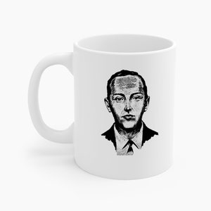 以下が含まれることがあります： 白のセラミックマグカップ。白黒の肖像画イラストが描かれています。肖像画は、スーツとネクタイ姿の男性の詳細なスケッチです。マグカップには湾曲したハンドルが付いています。