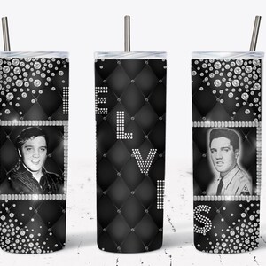 May include: A black and white tumbler featuring images of Elvis Presley. The tumbler has a diamond pattern with the name "ELVIS" spelled out in white rhinestones. Rhinestone accents and a silver straw complete the design.
