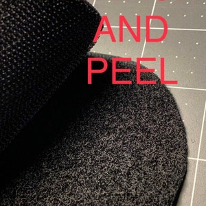May include: Close-up of black hook and loop fastener with the text "ATTACH AND PEEL" and "Backing included" printed in red.