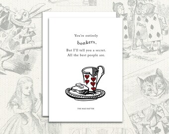 May include: A white card with black text and a black and red illustration of a broken teacup and a piece of bread on a plate. The text reads "You're entirely bonkers. But I'll tell you a secret. All the best people are." and "THE MAD HATTER".