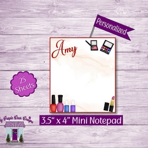 May include: A personalized 3.5" x 4" mini notepad with 25 sheets. The notepad has a marble background with a pink and white design. The notepad has a red border and features a variety of makeup items, including nail polish, lipstick, and eyeshadow.