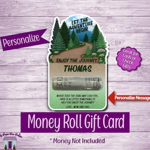 May include: A money roll gift card with a scenic design featuring a road through a forest. The card includes the text "Let the Adventure Begin" and "Enjoy the Journey". The card is designed to hold rolled cash and can be personalized.
