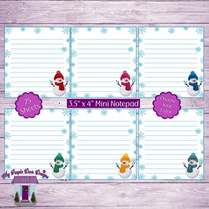 May include: A set of 25 mini notepads featuring a snowman design. Each notepad is 3.5 inches by 4 inches and has a blue border with snowflakes. The snowmen are wearing different colored hats: red, pink, green, orange, and blue. The text "Choose Your Color" is on one of the notepads.
