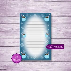 May include: A blue notepad with a winter theme featuring a hot chocolate design. The notepad has 25 sheets and measures 4 inches by 6 inches. It says "4"x"6" Notepad" on the bottom right corner.